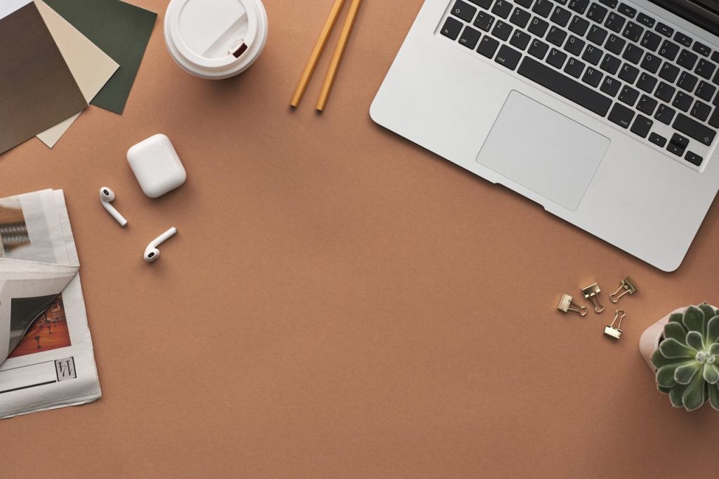 pexels-photo-3184464 Flat lay of a modern workspace with a laptop, AirPods, and coffee for productivity.